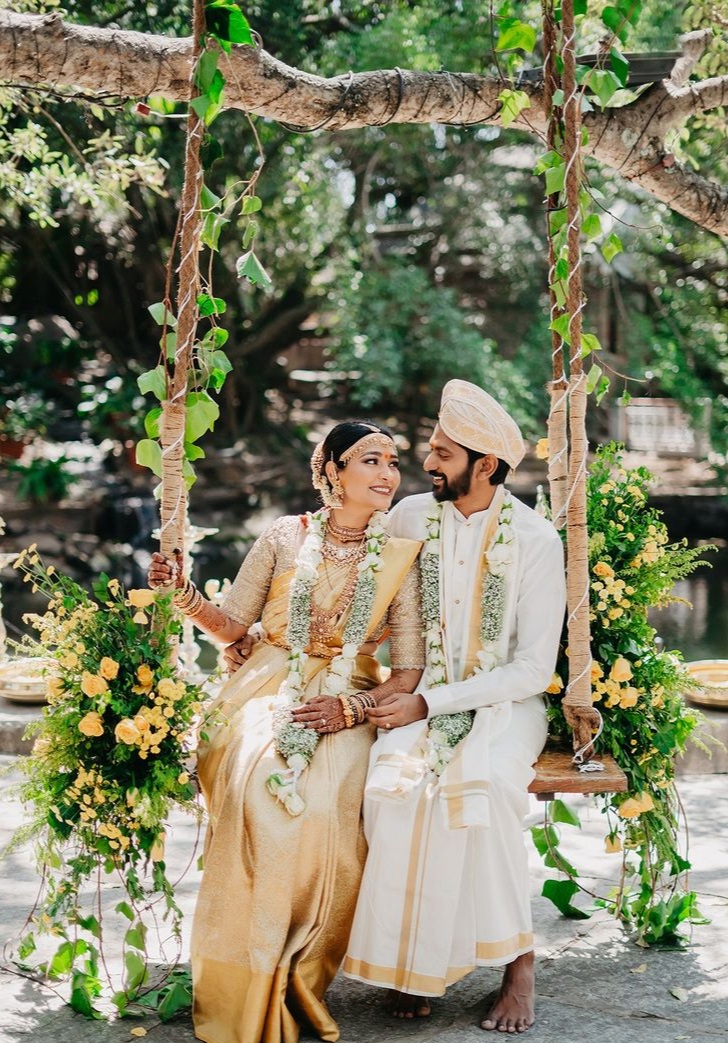 Nature-inspired pre-wedding photoshoot with a couple sitting together, glowing in their wedding attire