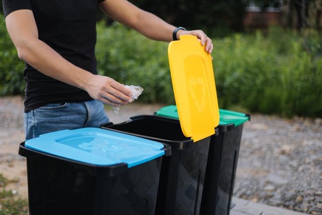 A person putting garbage into bins

AI-generated content may be incorrect.