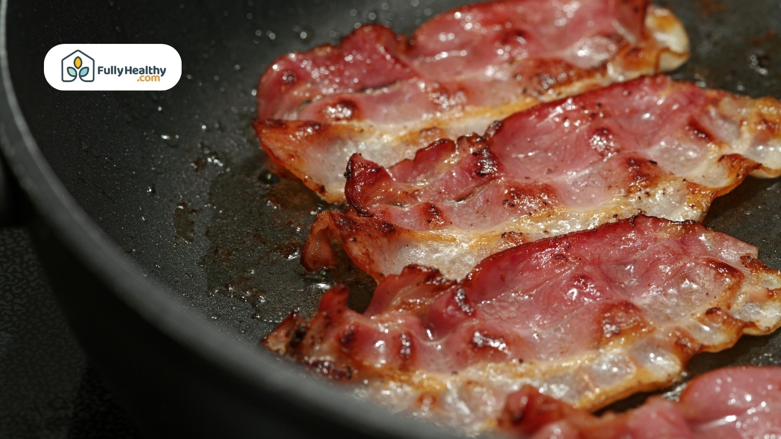 Bacon strips being fried in a pan