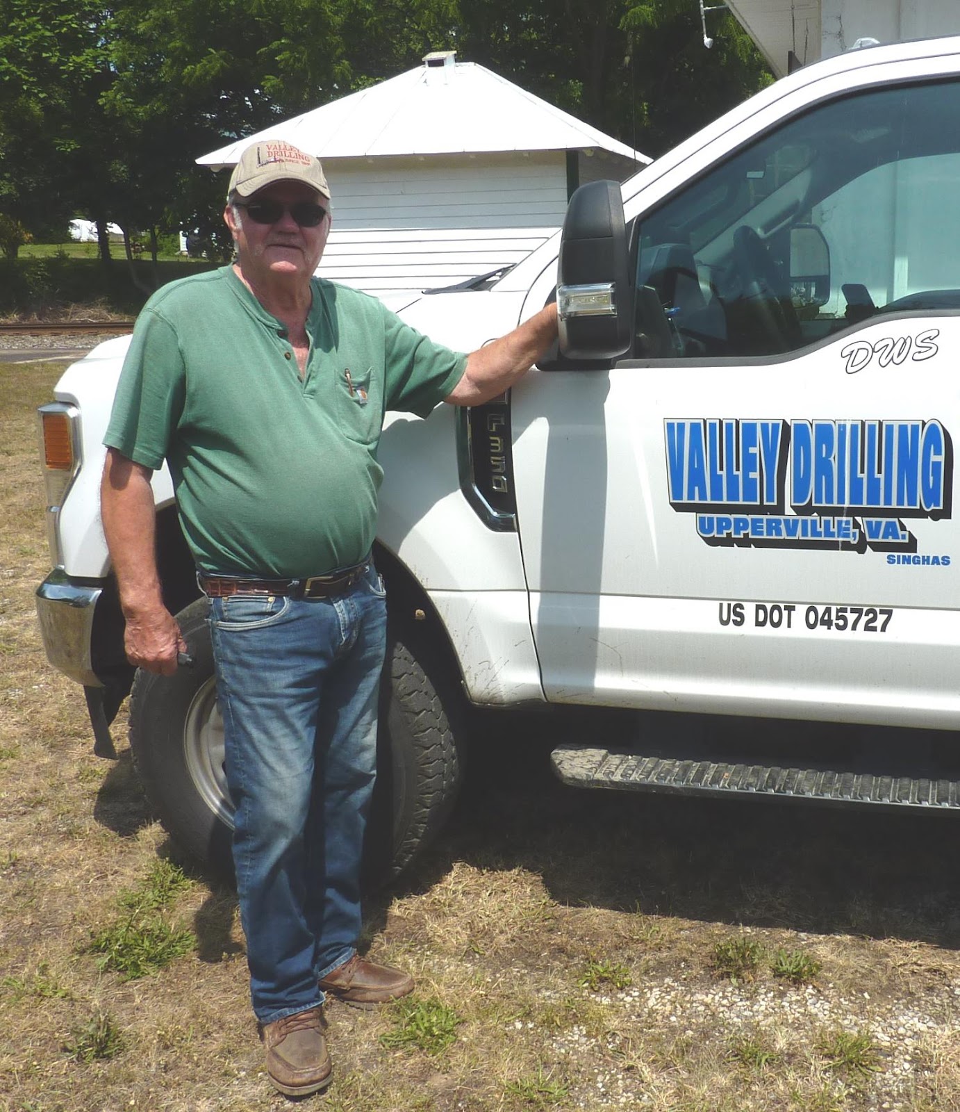 A person standing next to a white truckDescription automatically generated