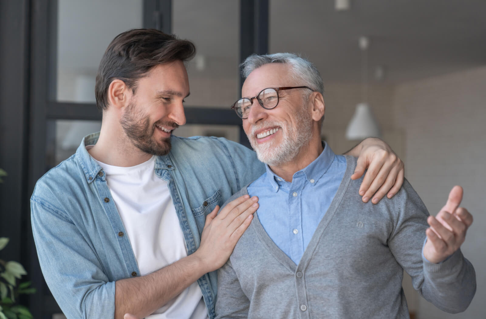 A young man having a conversation with his older adult father.