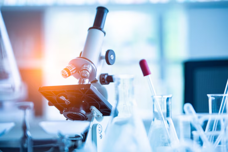 light-microscope-on-laboratory-table-surrounded-by-glass-flasks-and-test-tubes-in-bright-research-environment-cartalax-protocol-blueprint-from-systemic-repair-to-peak-recovery-tony-huge