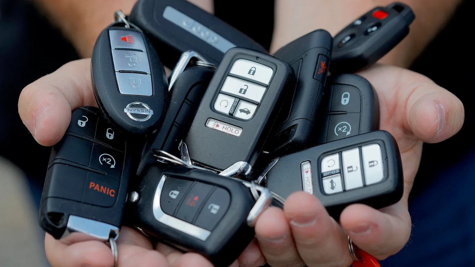 A collection of car key fobs, suggesting professional reprogramming services.