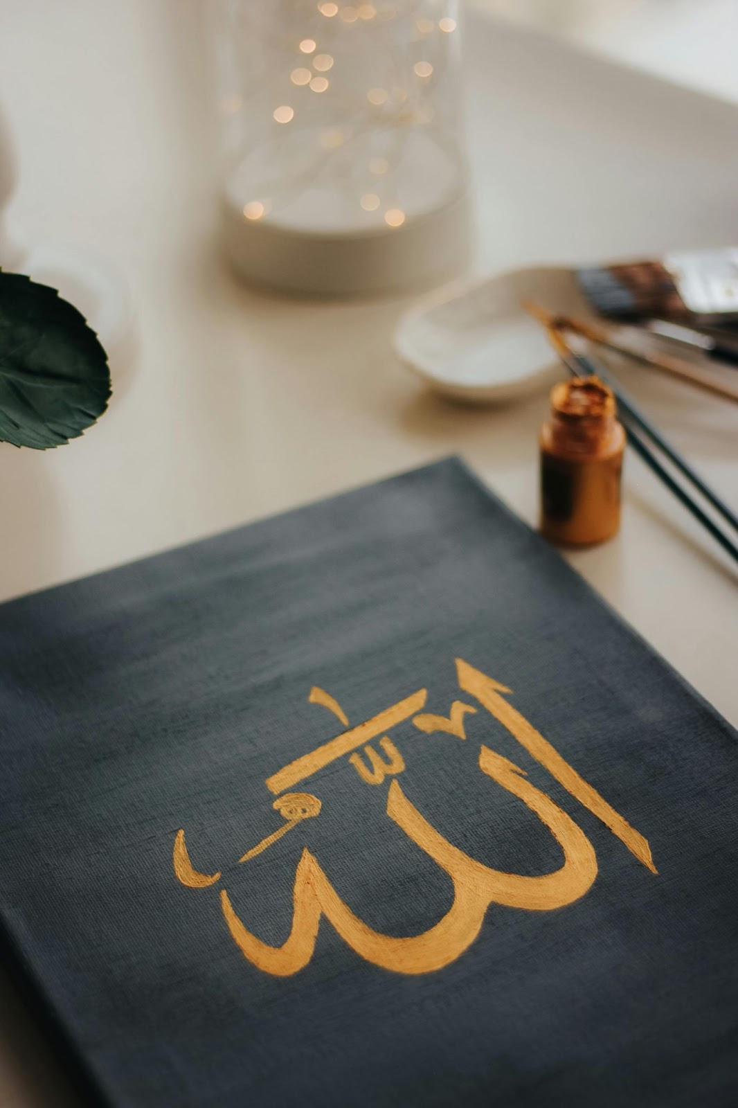 Arabic calligraphy of the word Allah written on a canvas in a beautiful artistic style