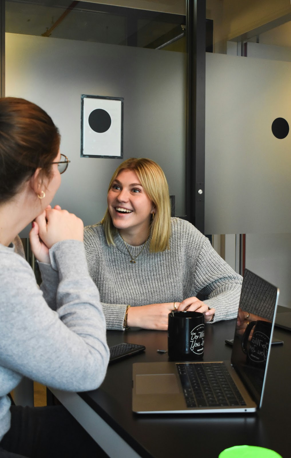 A woman talking to another woman with interest