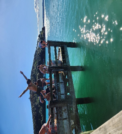 A group of people jumping into the water AI-generated content may be incorrect.
