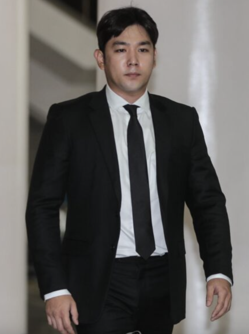 Super Junior member Kangin wearing a black suit 