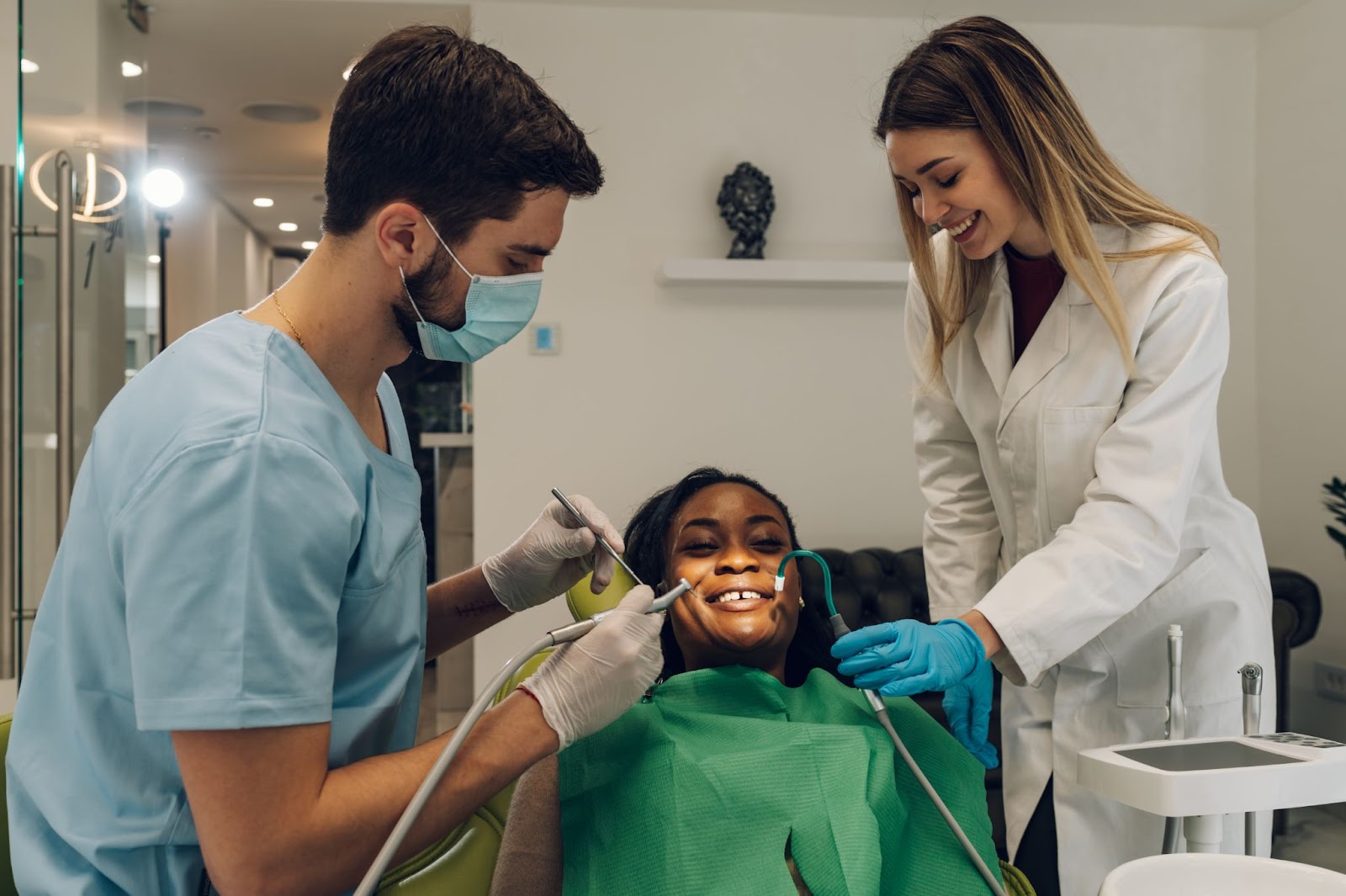 Oral Surgeon doing tooth implant surgery with an assistant