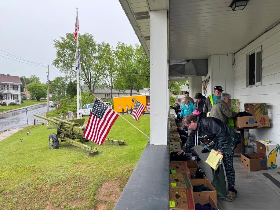 A group of people standing outside a building with a flag

AI-generated content may be incorrect.