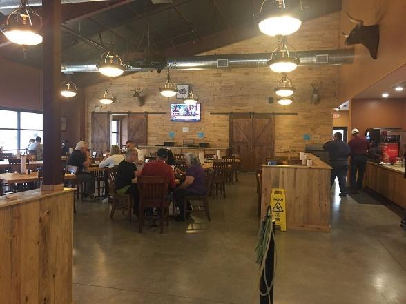 A group of people sitting at tables in a restaurant