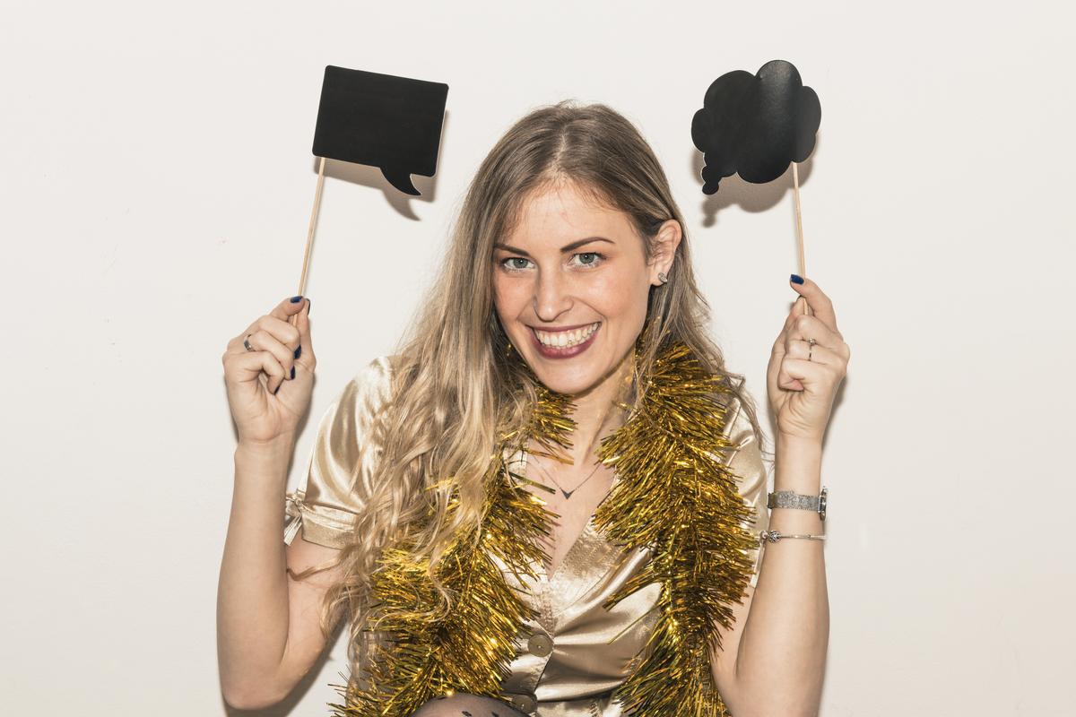 A woman using props while posing for a photo
