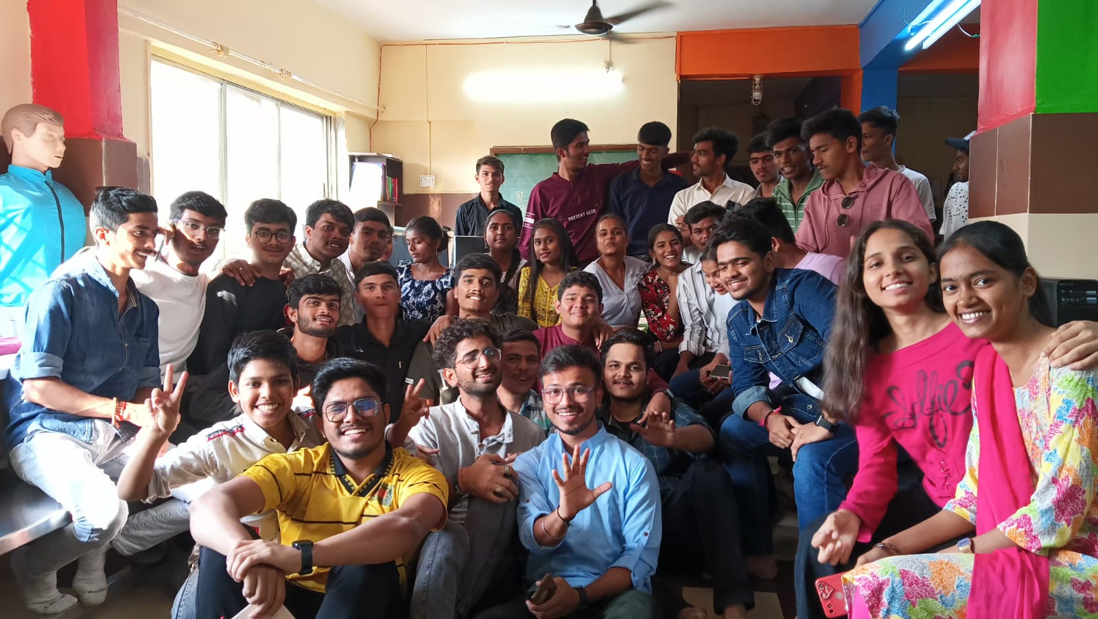 An illustration of a group of people posing for a photo indoors. The individuals are smiling and standing against a wall after learning valuable digital skills through resources