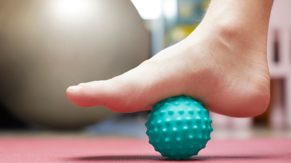 Person getting a foot massage with a ball