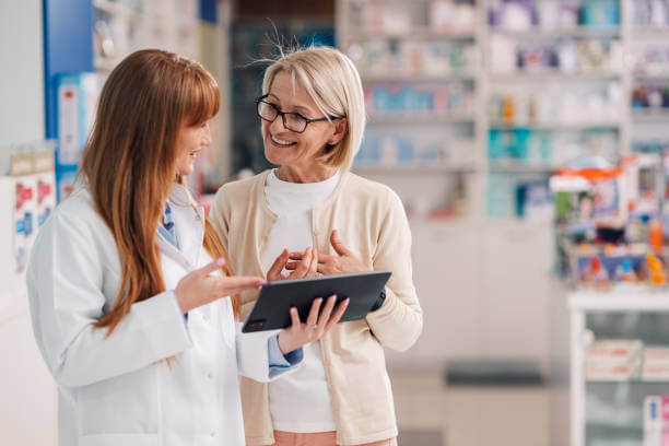 A friendly pharmacist and a patient smiling at each other, representing trusted healthcare support and expert advice at Phipps Pharmacy.