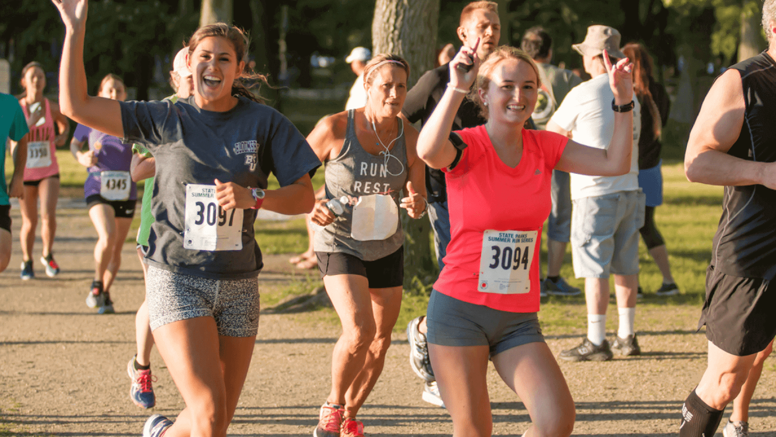 Runners waving and cheering