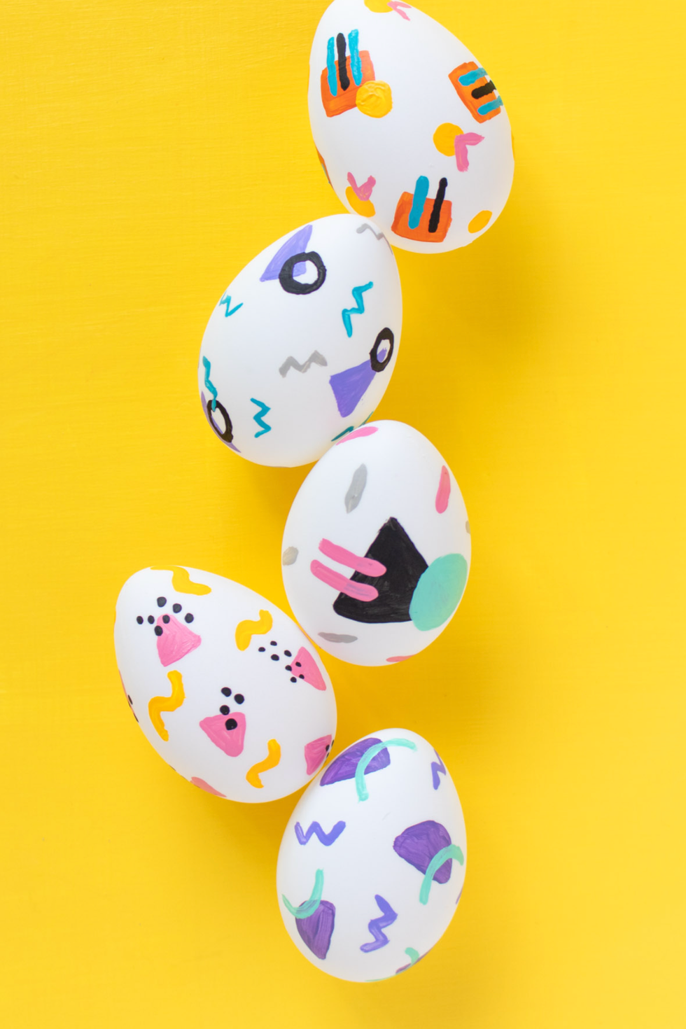 easter egg hunt ideas, five white eggs painted in a '90s pattern