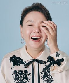 This contains a picture veteran actress Kim Soo Mi laughing and holding her hands to her face