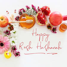 image of flowers, an apple, honey and pomegranate with text of Happy Rosh Hashanah