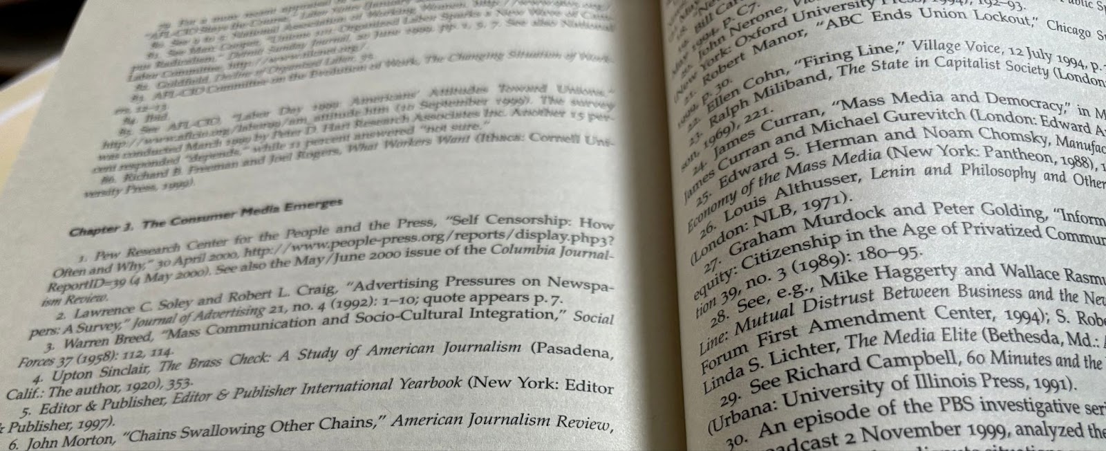 An open book with pages showing a references list.