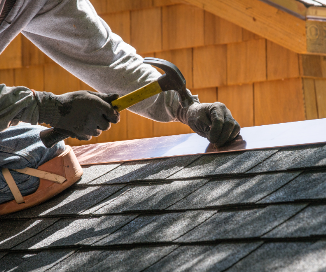 a man hammering a roof flashing