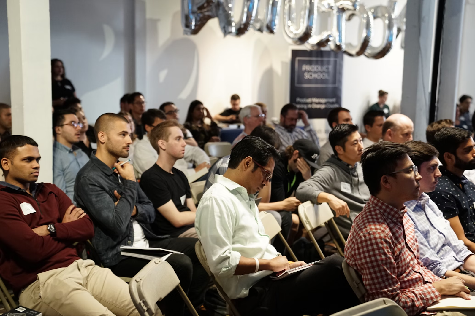 Several people sitting in a row during orientation training