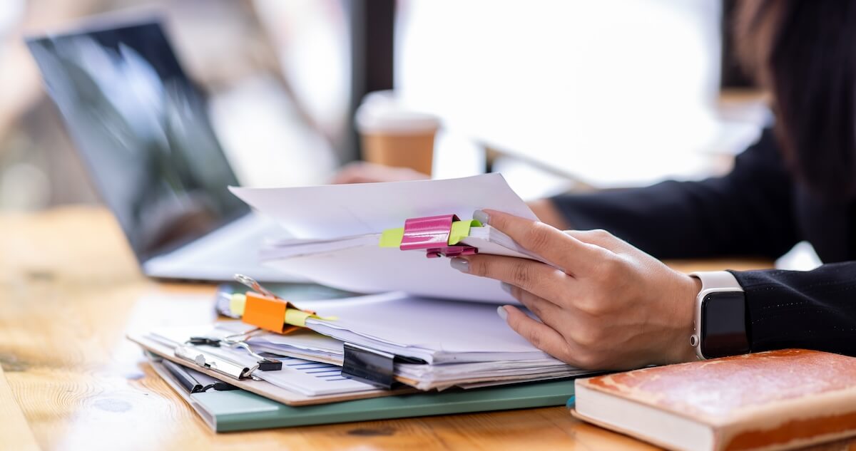 How does intermittent FMLA work: employee reviewing a stack of documents