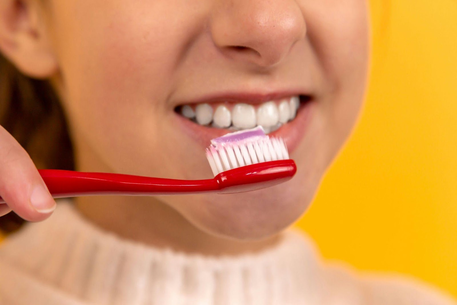 A girl brushing her teeth toothpaste allergy