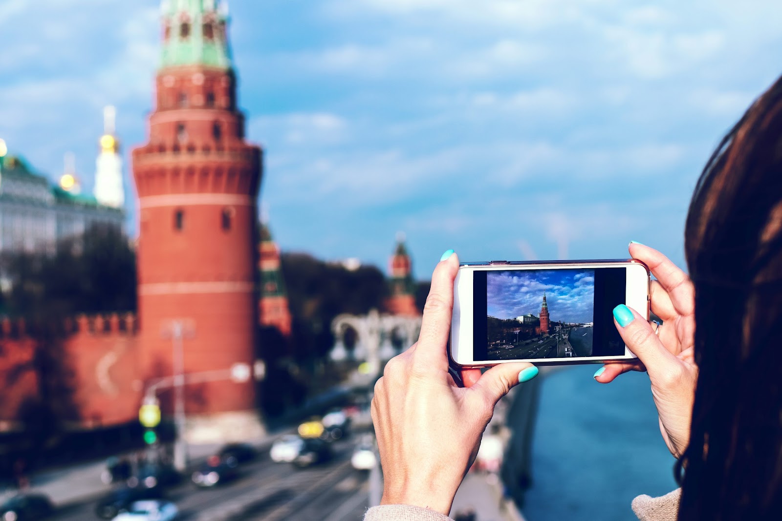 person holding white android smartphone taking photo of tower during daytime