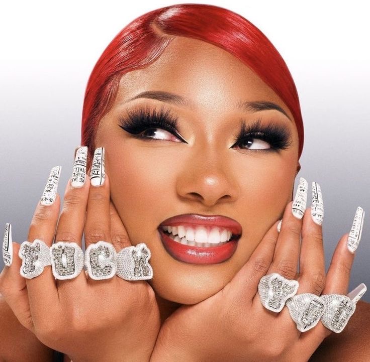 Alt Image: Megan Thee Stallion wearing a red wig. Image sourced from @theestallion on Instagram.