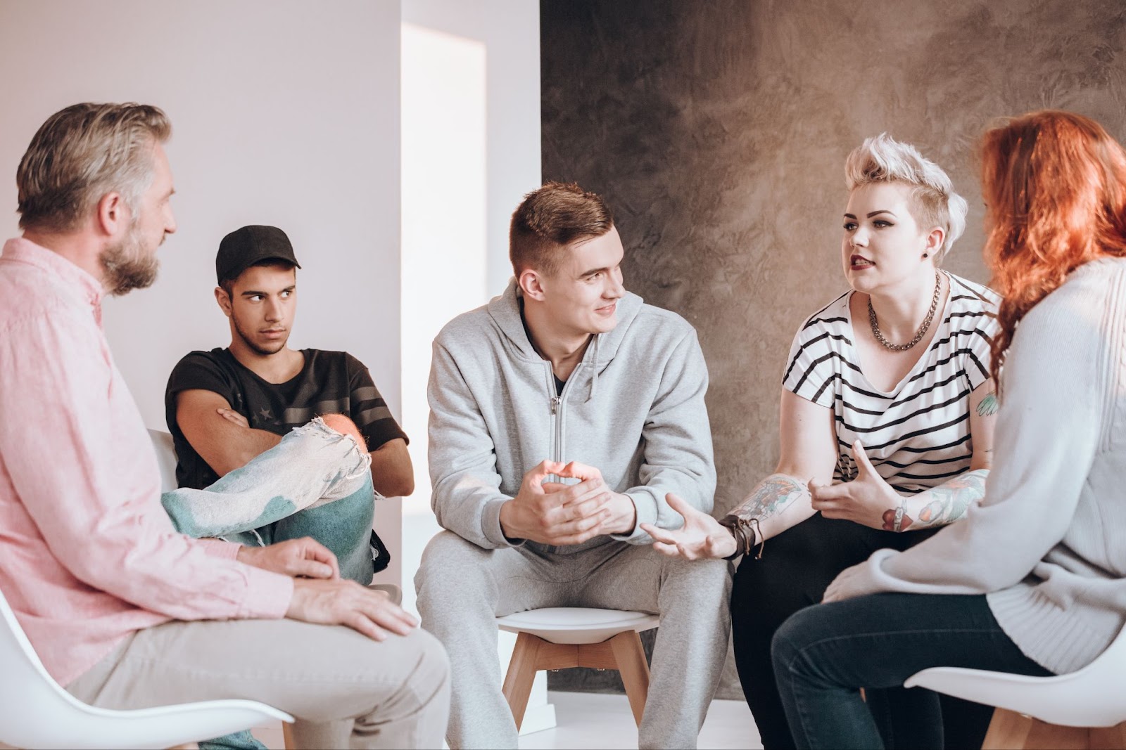 Men and women in a support group sitting in a circle.