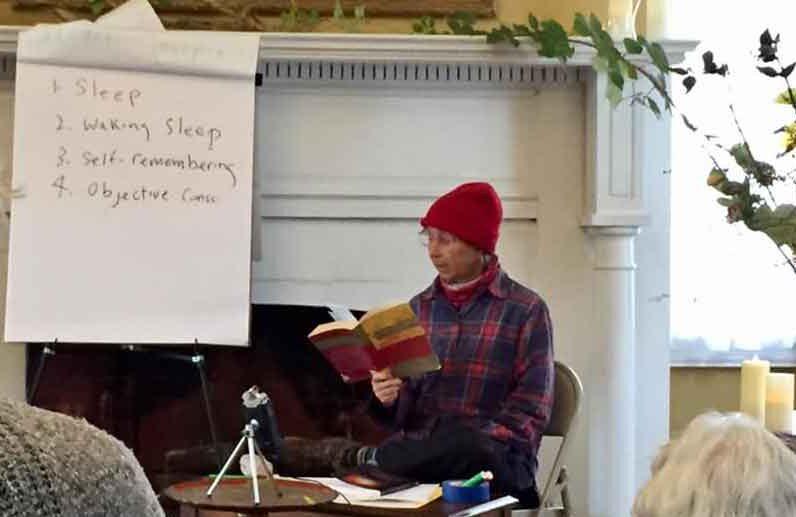 A person in a red hat reading a book

Description automatically generated