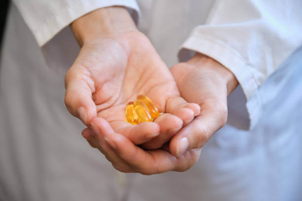 A healthcare expert holding brain supplements in their hand, showcasing a professional and trusted approach to cognitive health.