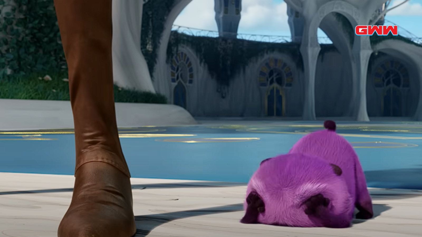 Close-up of a small, sleeping purple creature near a large foot played by Dee Bradley Baker