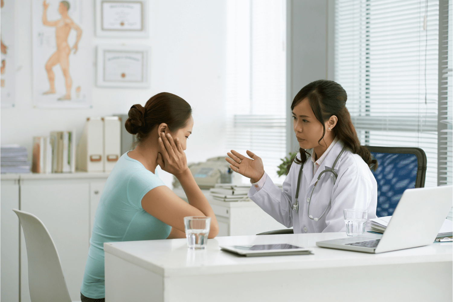 woman speaking with a female doctor as they review her medical history together