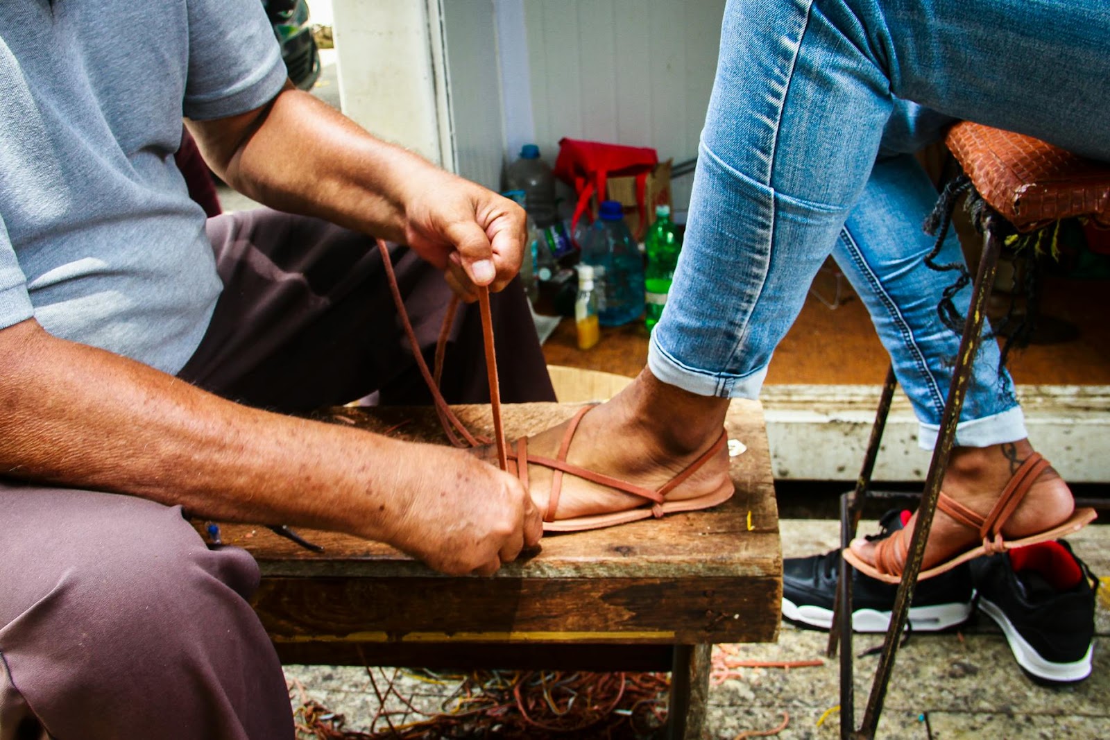 https://www.pexels.com/photo/man-making-handmade-leather-sandals-on-the-foot-of-a-woman-17994477/