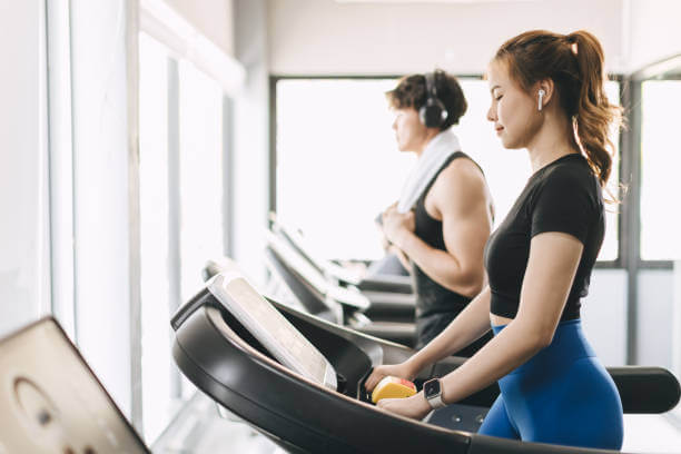 Two individuals engaging in exercise, symbolizing the balance of physical and mental health in holistic wellness.