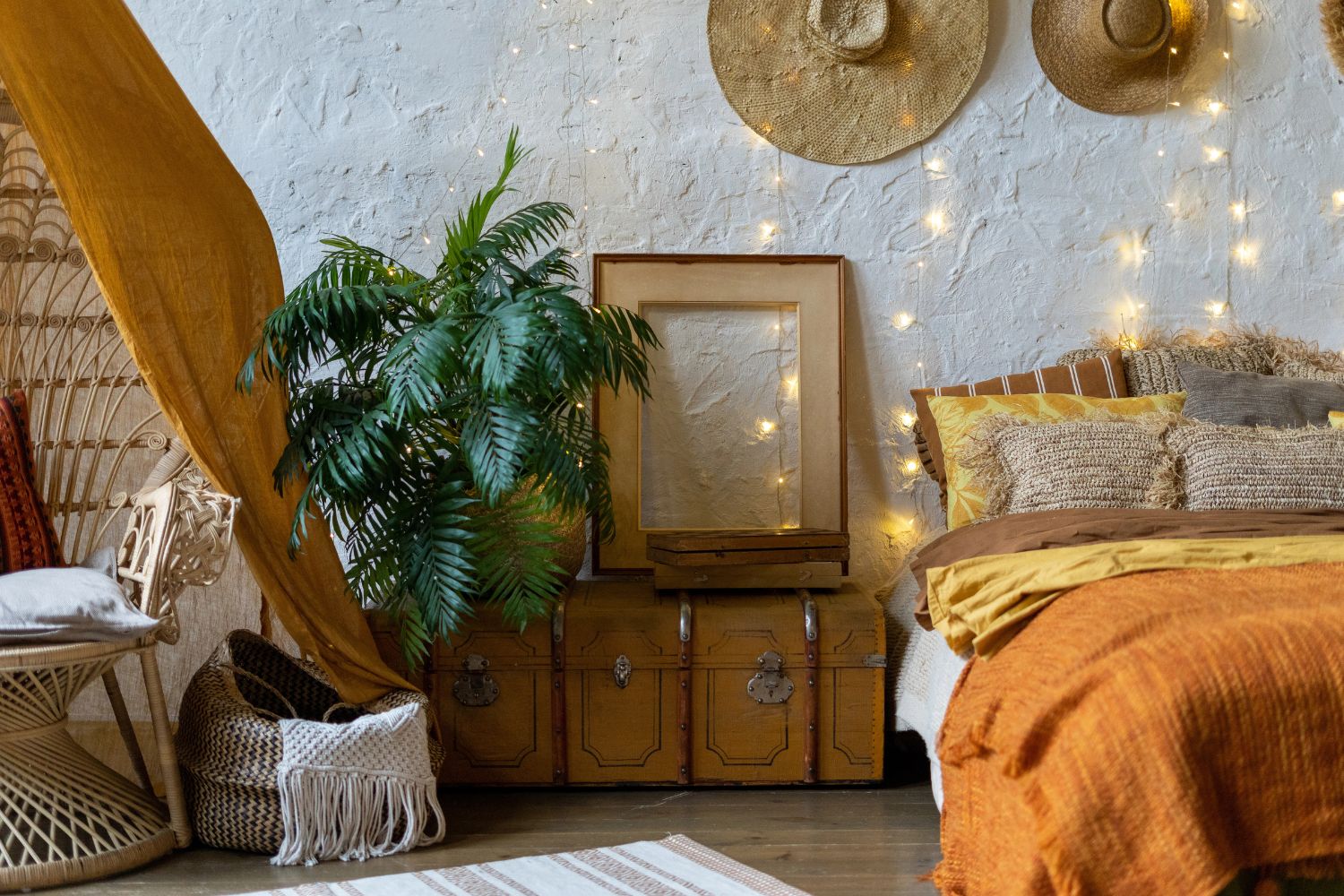 bohemian bedroom with string lights, potted plant, woven basket and furniture