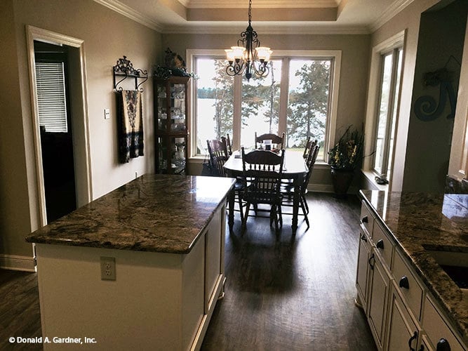 Across the kitchen is the dining area drenched in natural light.