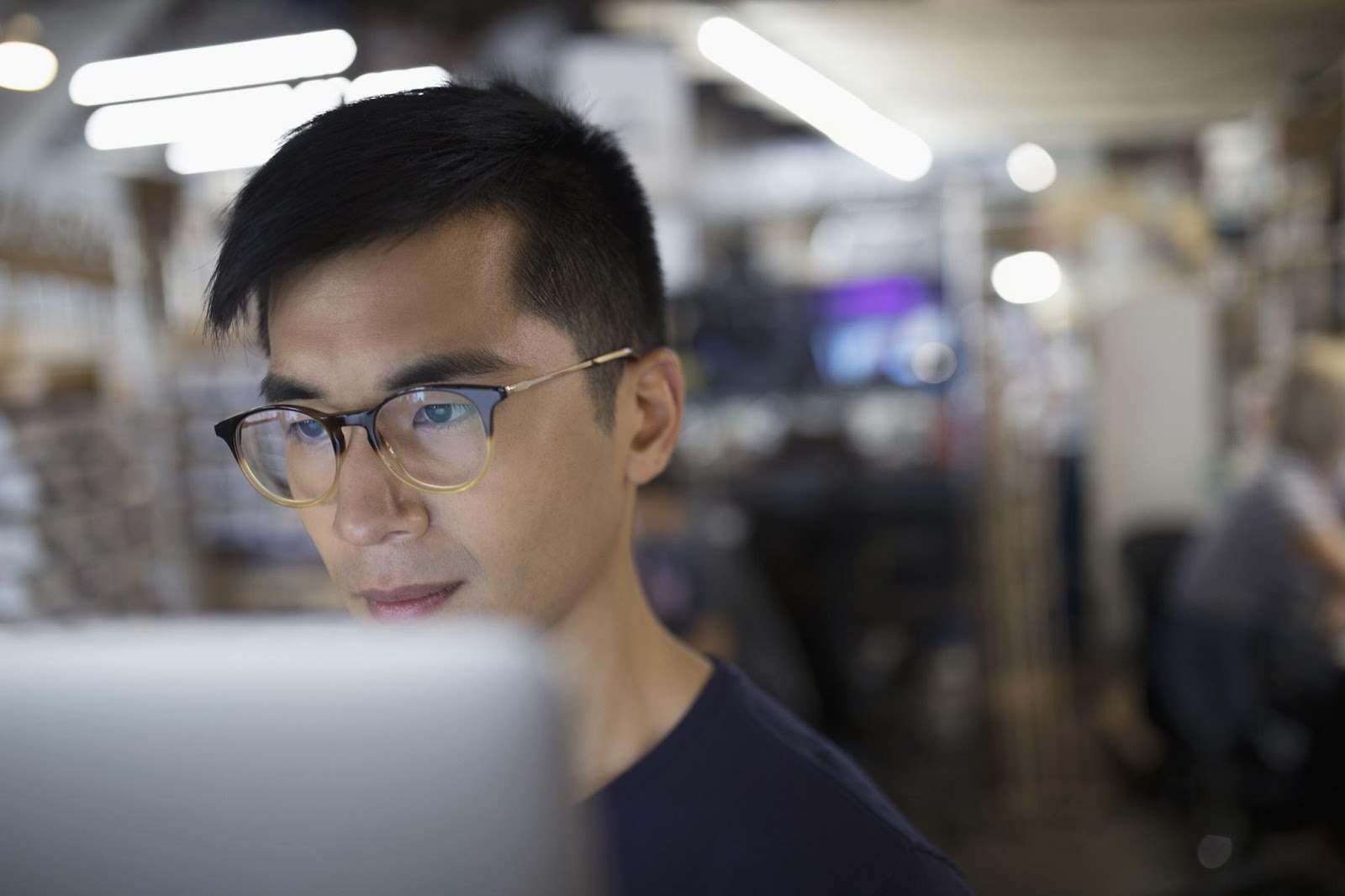 Focused male engineer working at computer