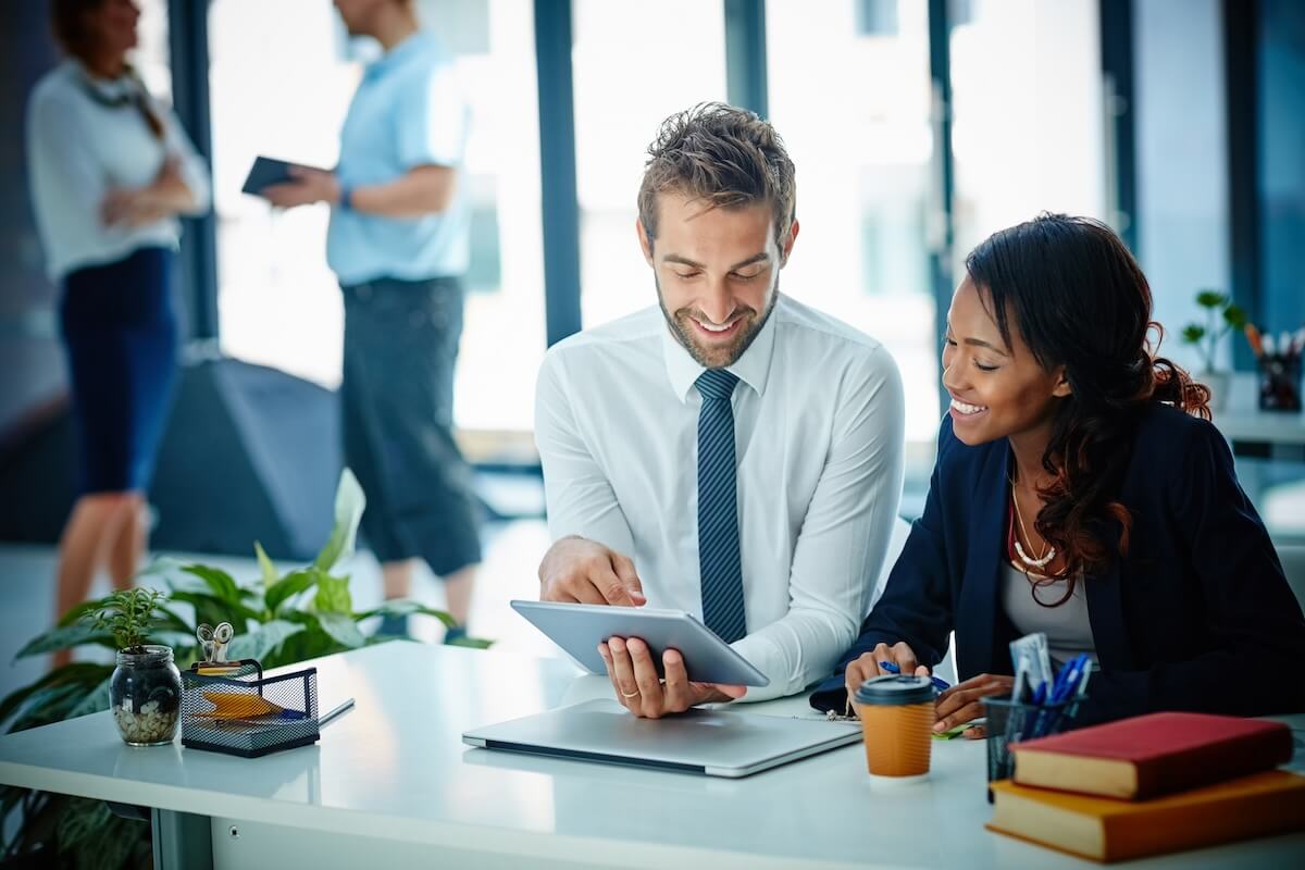 Recruitment and retention: colleagues looking at a tablet