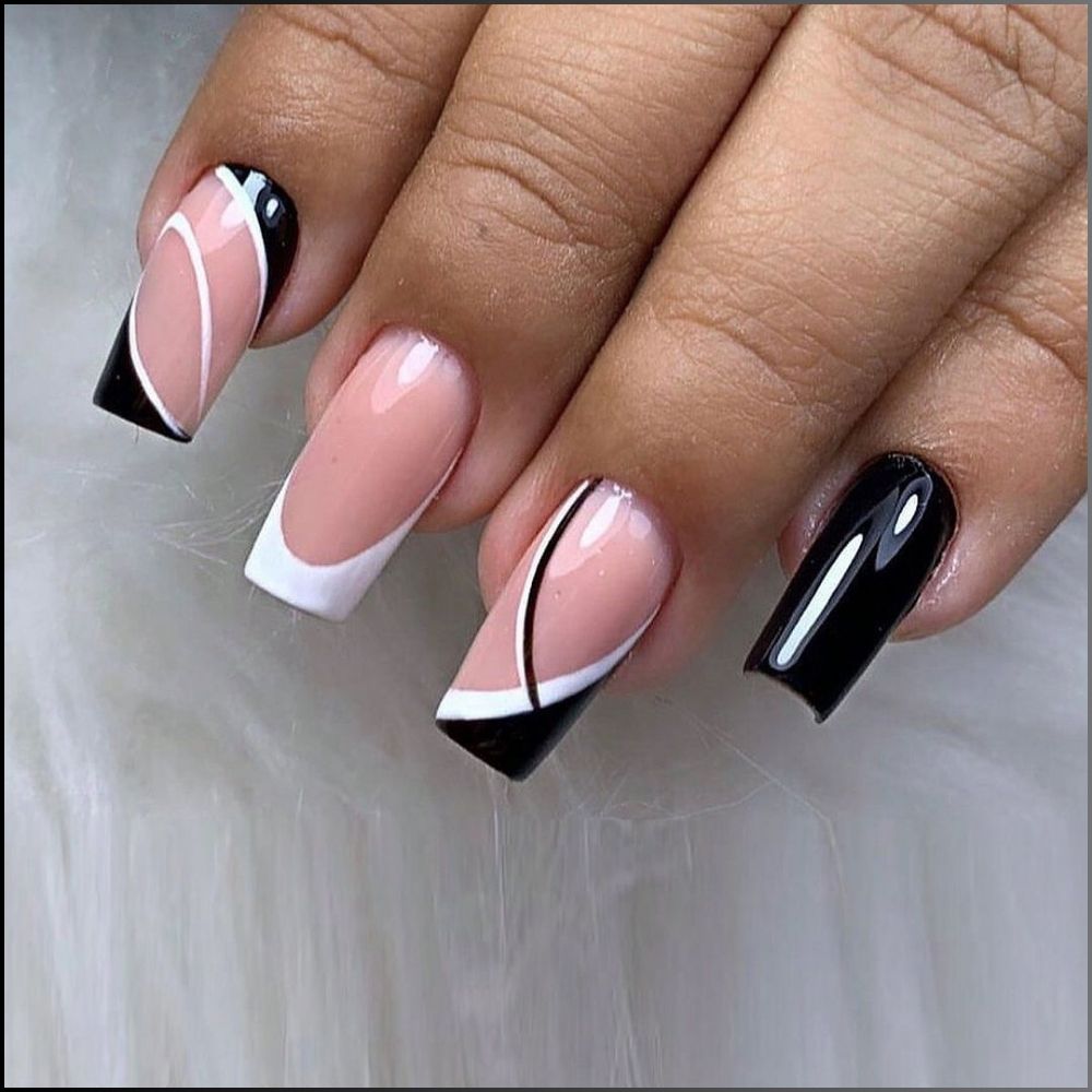 Zoom in view of hand with simple French tip nail having Curved white and black lines