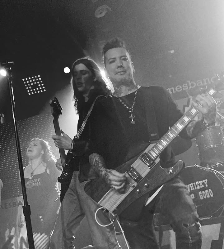 Leland Francis Fraser playing the guitar with his band