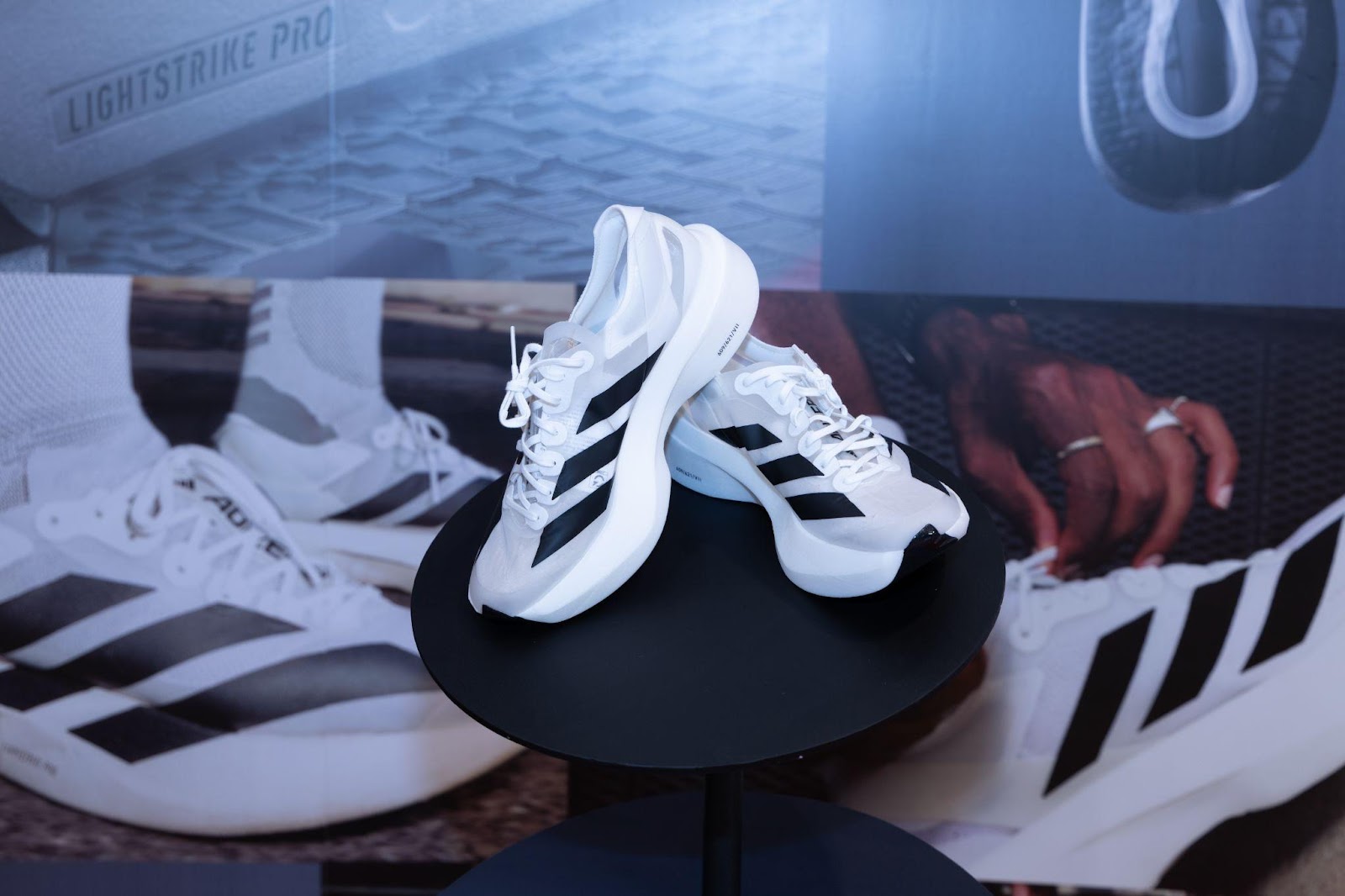 A pair of white shoes on a table

Description automatically generated