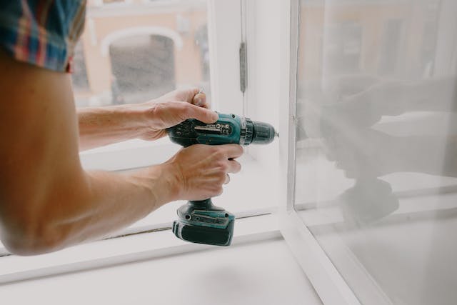 A doorframe being fixed with a drill