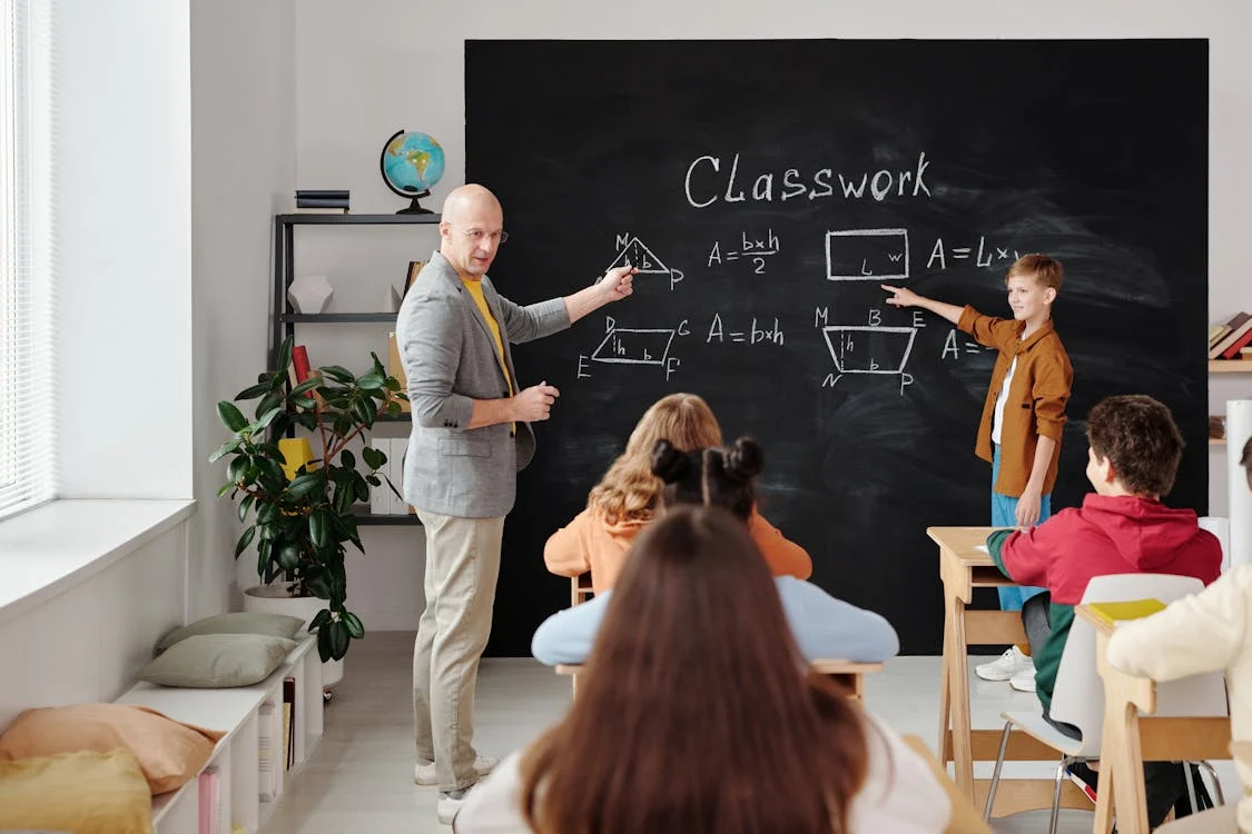 A teacher teaching maths to students