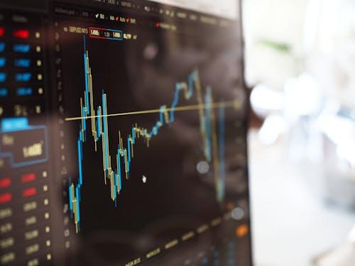 Free Detailed view of financial trading graphs on a monitor, illustrating stock market trends. Stock Photo