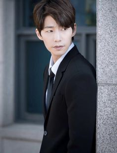 This contain an image of Song Jae Rim on suit 