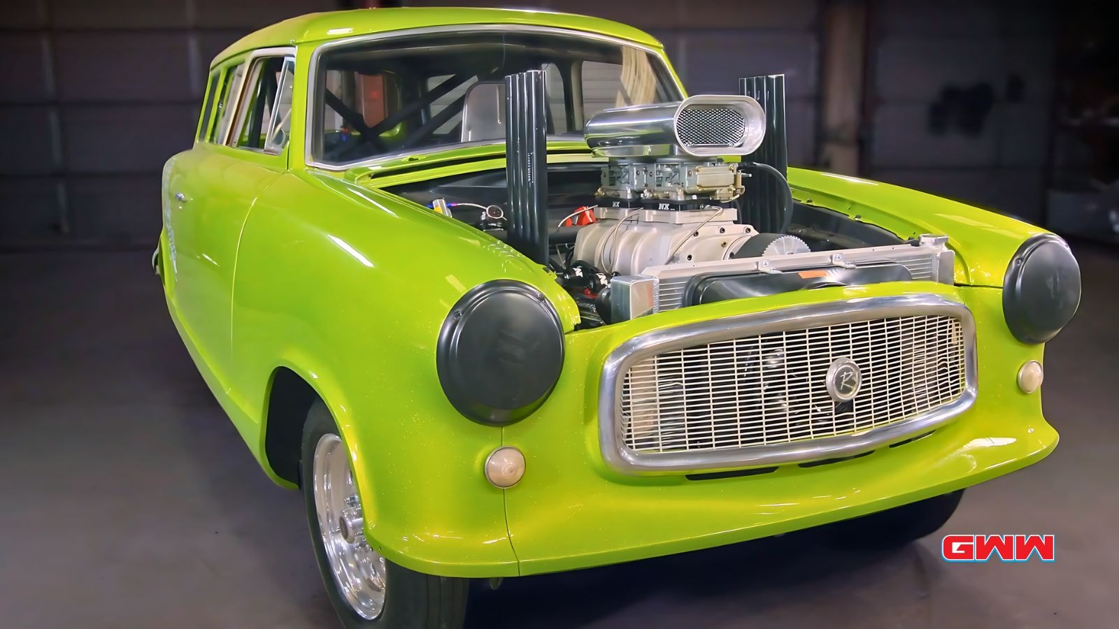 Bright green vintage car with exposed engine from Tex Mex Motors.