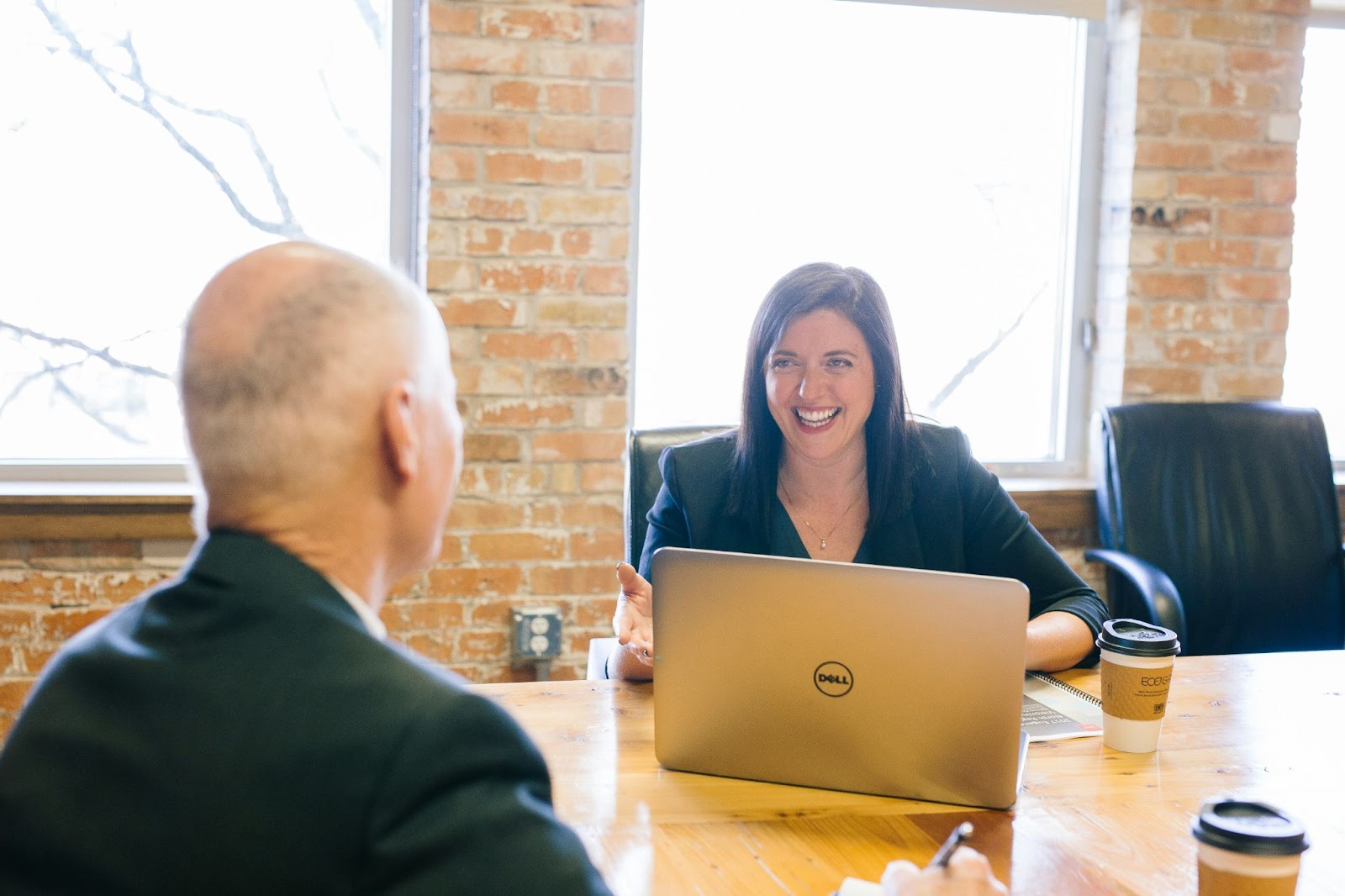 people at a desk smiling