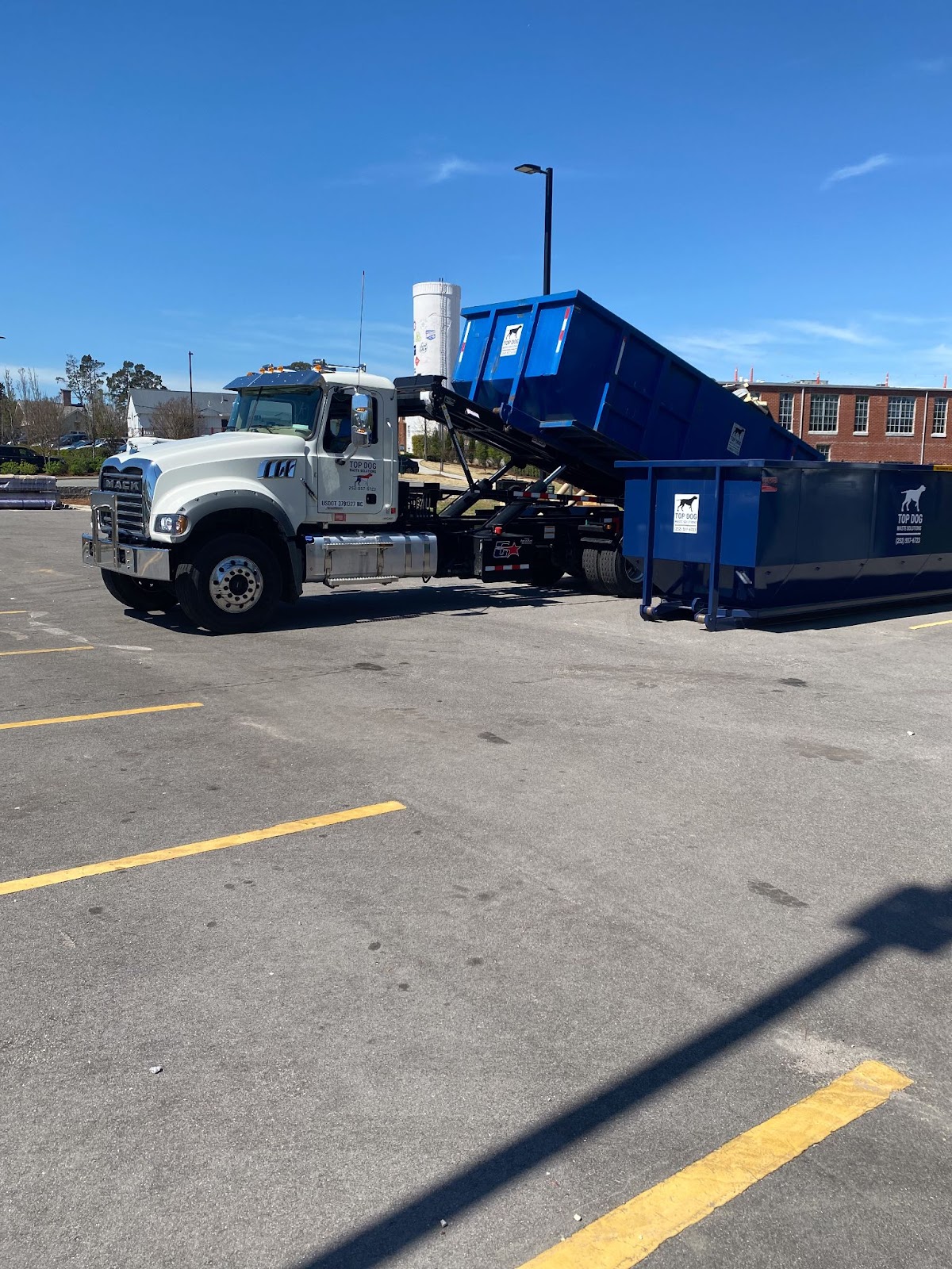 Dumpster on the back of a truck. 